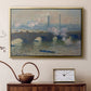 Gold floater framed canvas featuring a river and bridge scene with diffused light and urban backdrop, displayed above a cabinet in a soft-toned living room.