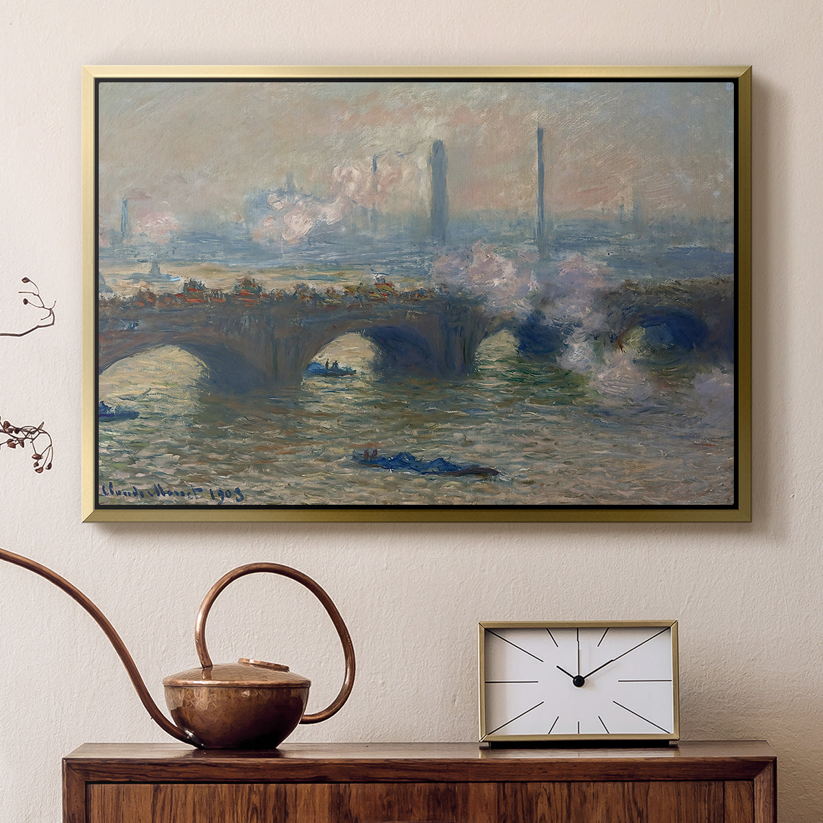 Gold floater framed canvas featuring a river and bridge scene with diffused light and urban backdrop, displayed above a cabinet in a soft-toned living room.