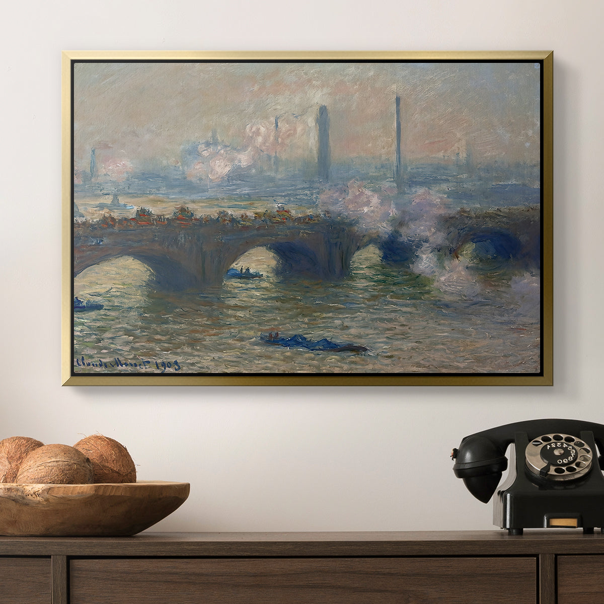Waterloo Bridge, Gray Day, 1903 by Claude Monet in a gold floater framed canvas displayed above a console table in a hallway, featuring a foggy London bridge view with softened architectural forms.