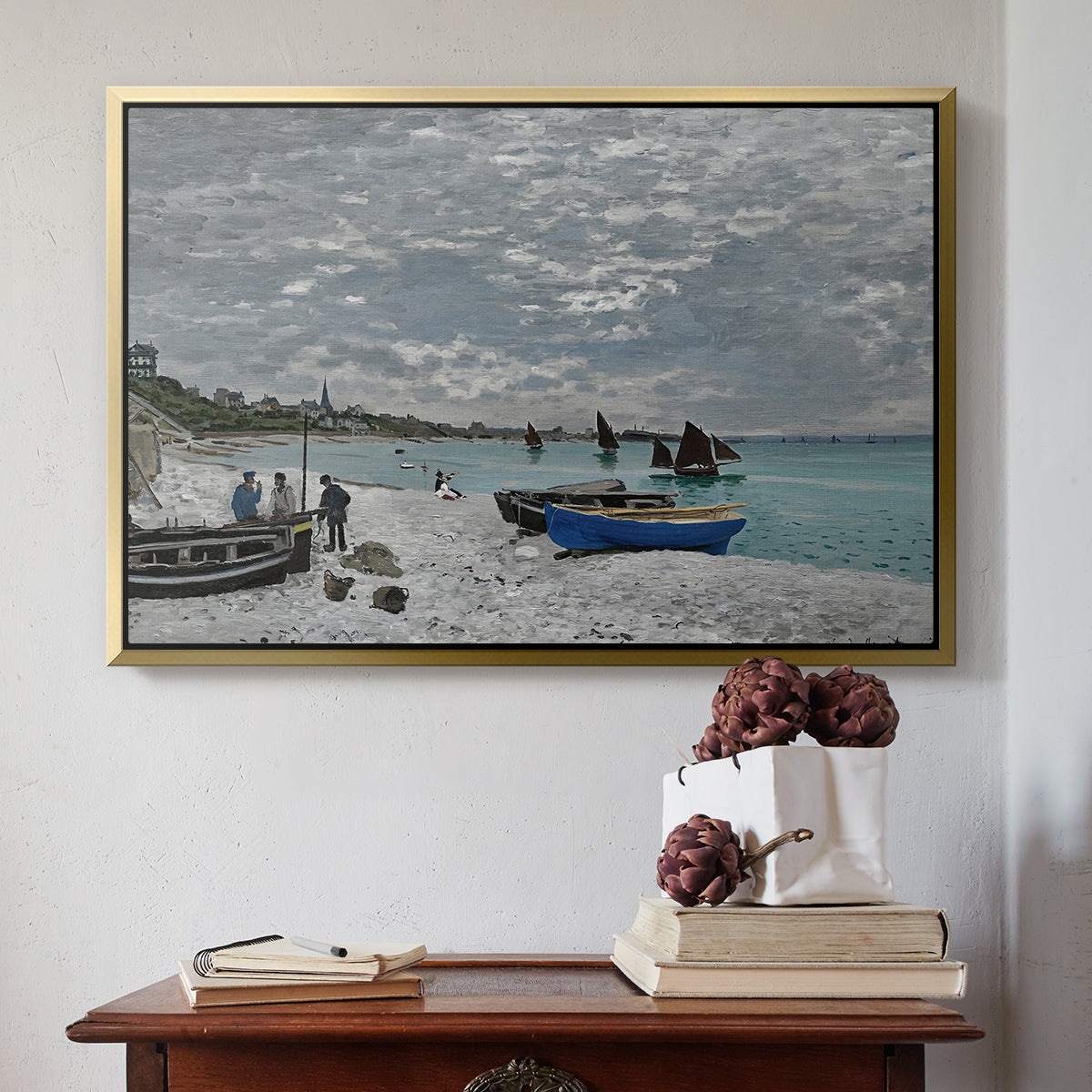 Gold floater framed canvas featuring The Beach at Sainte-Adresse, 1867 by Claude Monet above an entryway table in a minimalist foyer.