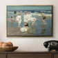A Holiday, c. 1915 by Edward Henry Potthast in a gold floater framed canvas displayed above a console table in a hallway, featuring a lively shoreline scene with people gathered in surf.