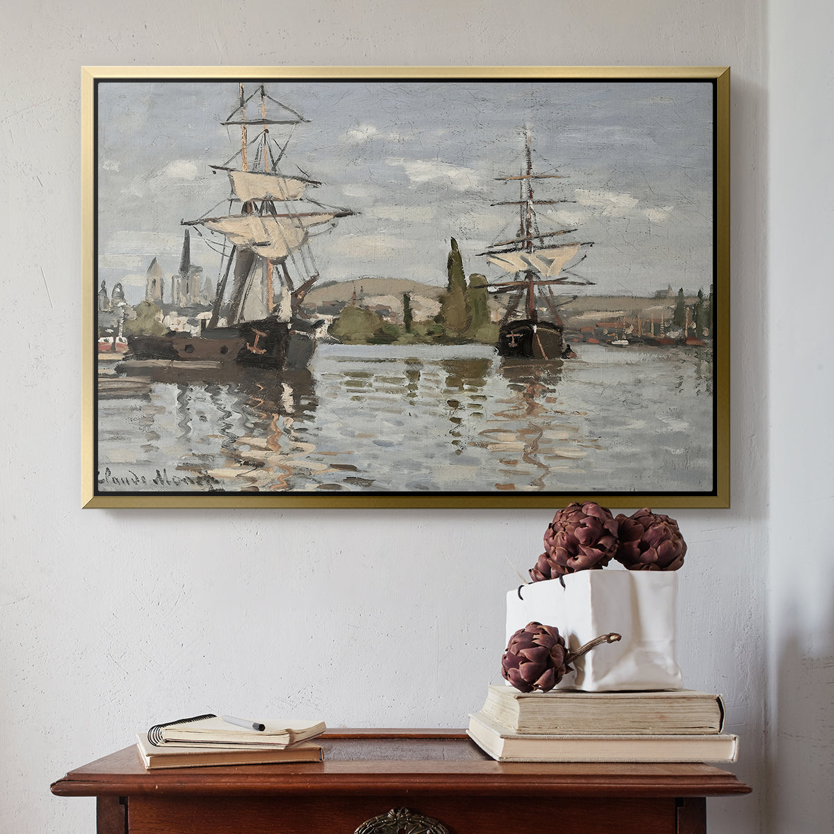 Gold floater framed canvas featuring Ships Riding on the Seine at Rouen, 1872 by Claude Monet above an entryway table in a minimalist foyer.