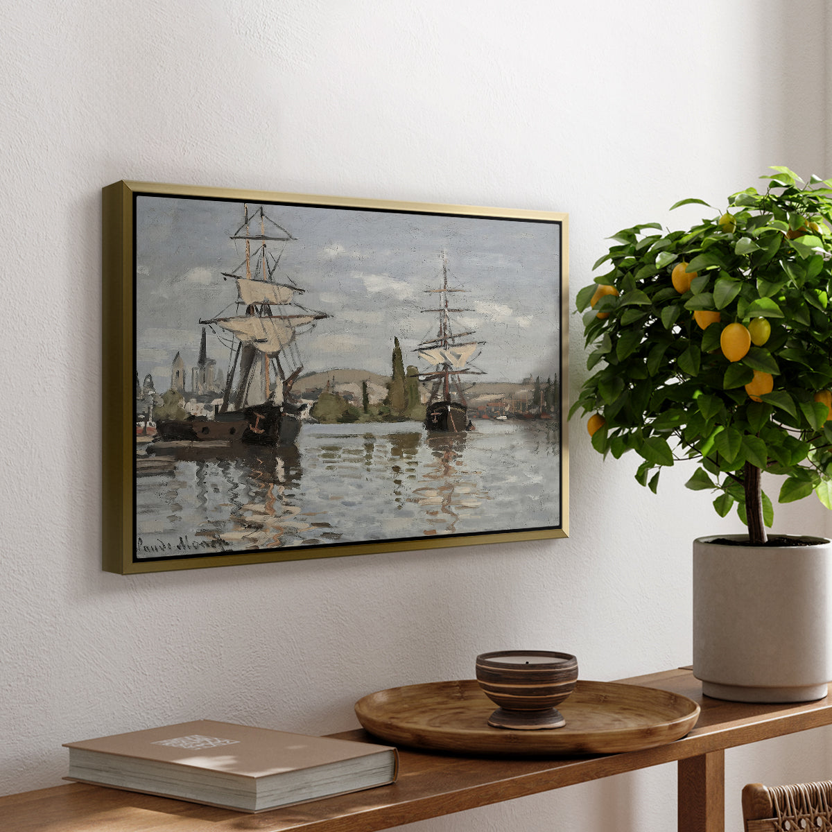Ships Riding on the Seine at Rouen, 1872 by Claude Monet, presented in a gold floater framed canvas featuring large ships docked along the Seine with masts rising against soft sky, displayed above a hallway console table.