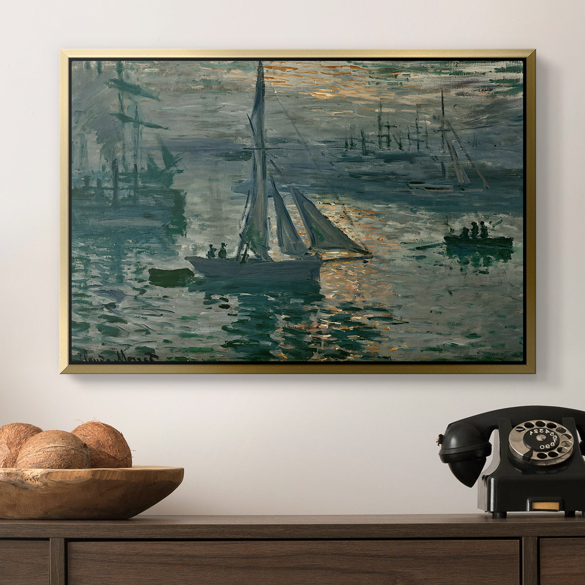 Sunrise (Marine), 1873 by Claude Monet in a gold floater framed canvas displayed above a console table in a hallway, featuring an atmospheric ocean view with sun rising through haze.