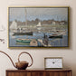 Gold floater framed canvas featuring a harbor basin filled with boats under soft sky, displayed above a cabinet in a soft-toned living room.