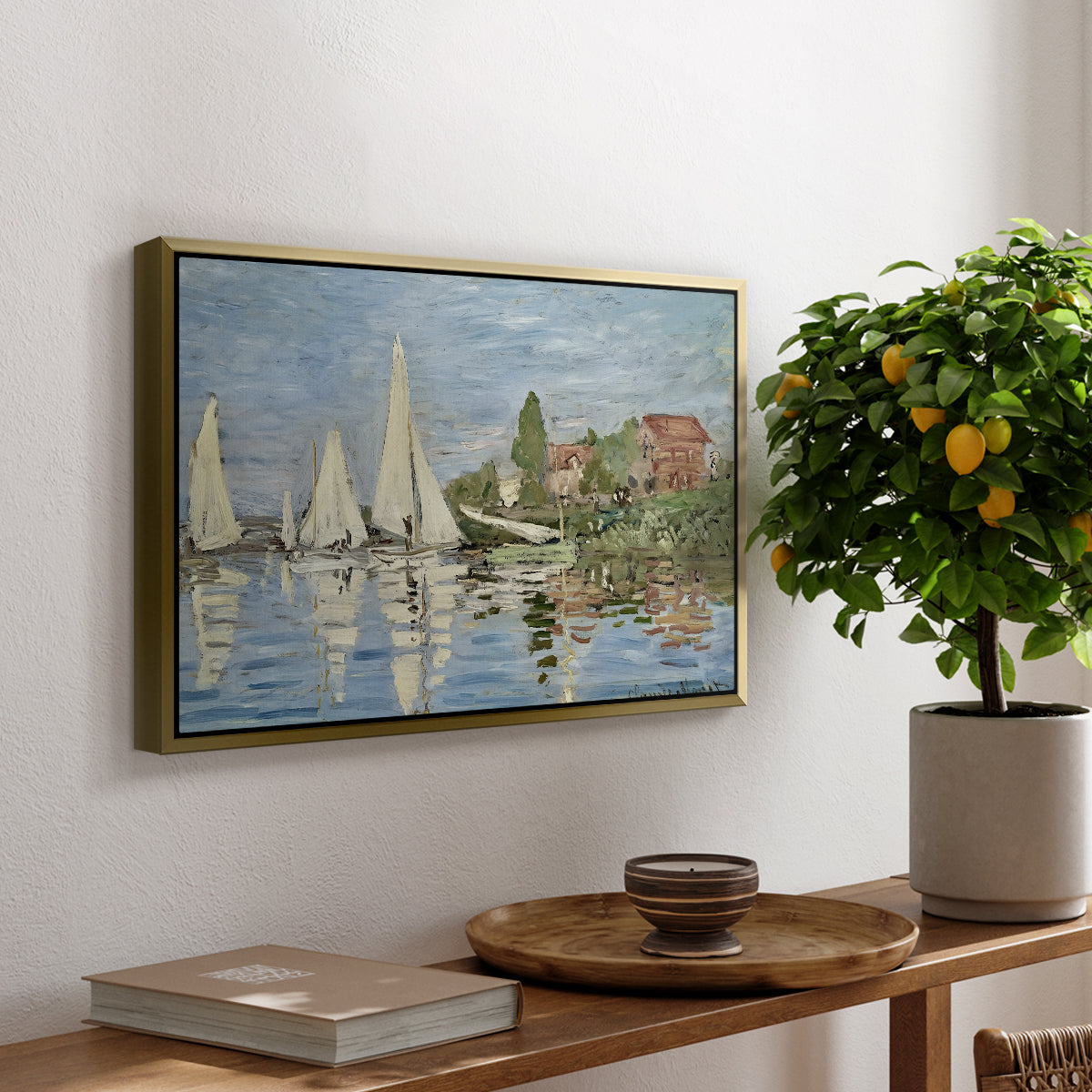 Regatta at Argenteuil, 1872 by Claude Monet, presented in a gold floater framed canvas featuring colorful sailboats racing across river under bright sky, displayed above a hallway console table.