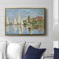 Regatta at Argenteuil, 1872 by Claude Monet displayed above a sofa in a living room in a gold floater frame, featuring a lively regatta scene with multiple boats and fluttering sails.