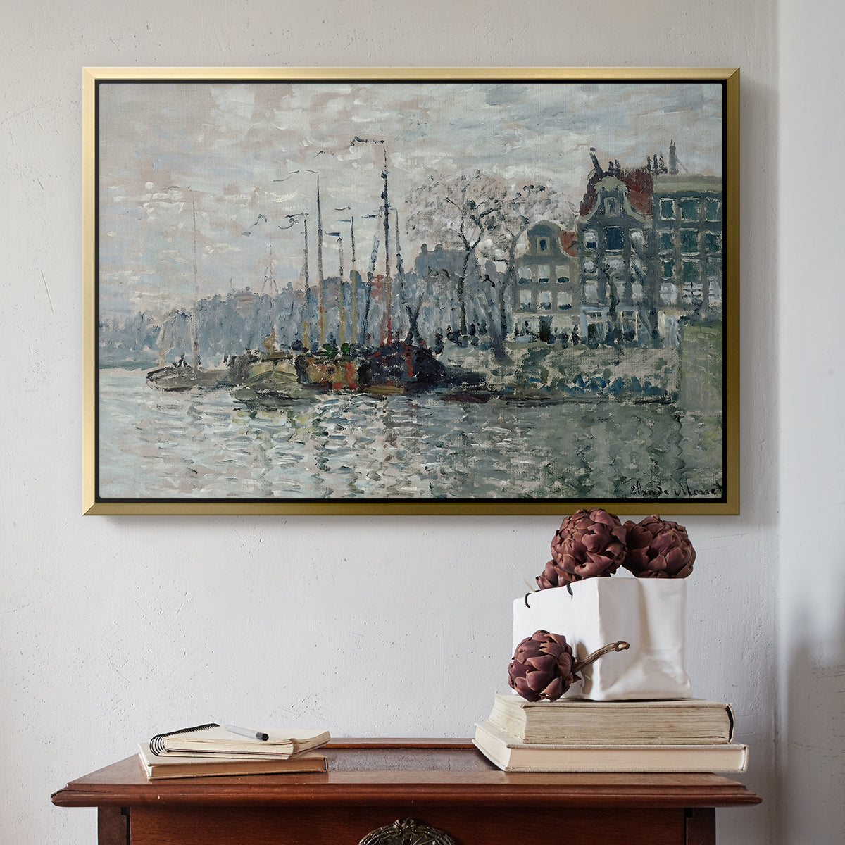 Gold floater framed canvas featuring View of the Prins Hendrikkade and Kromme Waal in Amsterdam, 1874 by Claude Monet above an entryway table in a minimalist foyer.