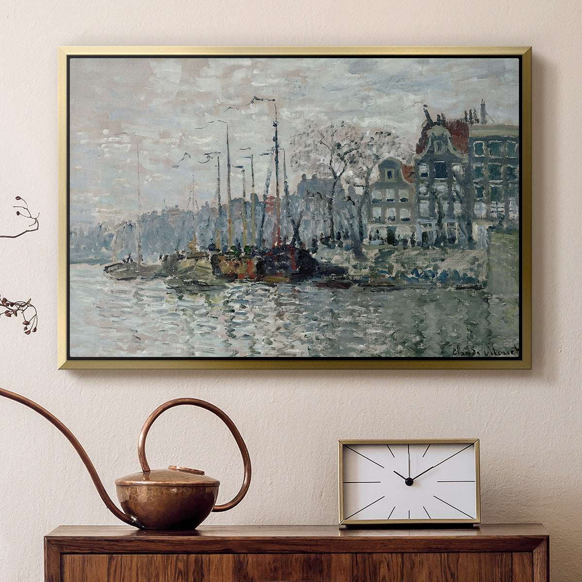 Gold floater framed canvas featuring an urban waterway with docked boats and European buildings, displayed above a cabinet in a soft-toned living room.