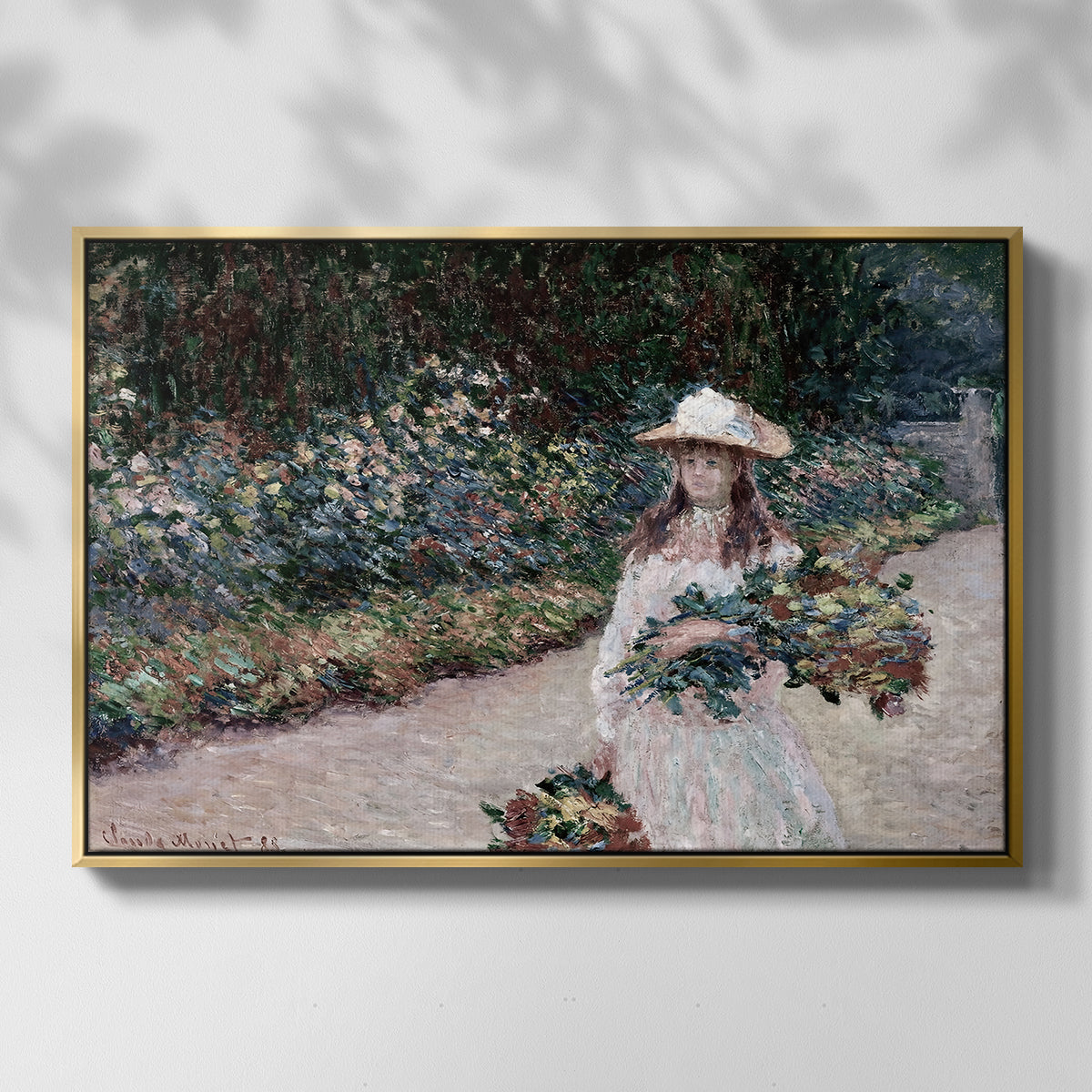 Front view of Young Girl in the Garden at Giverny, 1888 by Claude Monet in a gold floater framed canvas.