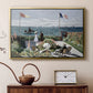 Gold floater framed canvas featuring a vibrant garden scene with colorful blooms and distant sea, displayed above a cabinet in a soft-toned living room.