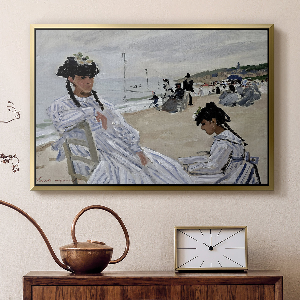 Gold floater framed canvas featuring a beach setting with people relaxing under umbrellas, displayed above a cabinet in a soft-toned living room.