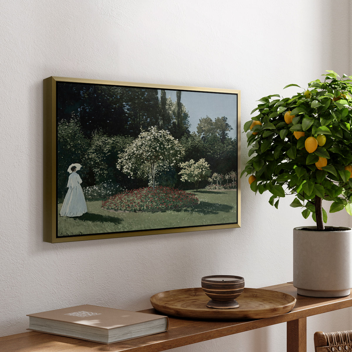 Woman in the Garden, Sainte-Adresse, 1867 by Claude Monet, presented in a gold floater framed canvas featuring a woman standing in garden surrounded by flowers and greenery, displayed above a hallway console table.
