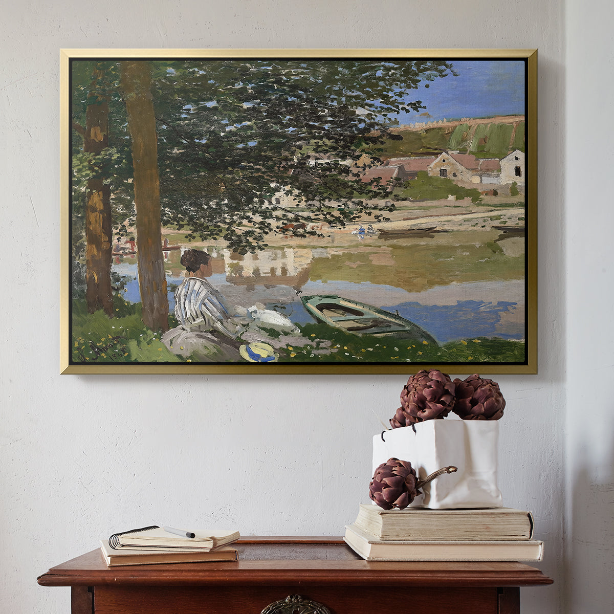 Gold floater framed canvas featuring On the Bank of the Seine, Bennecourt, 1868 by Claude Monet above an entryway table in a minimalist foyer.