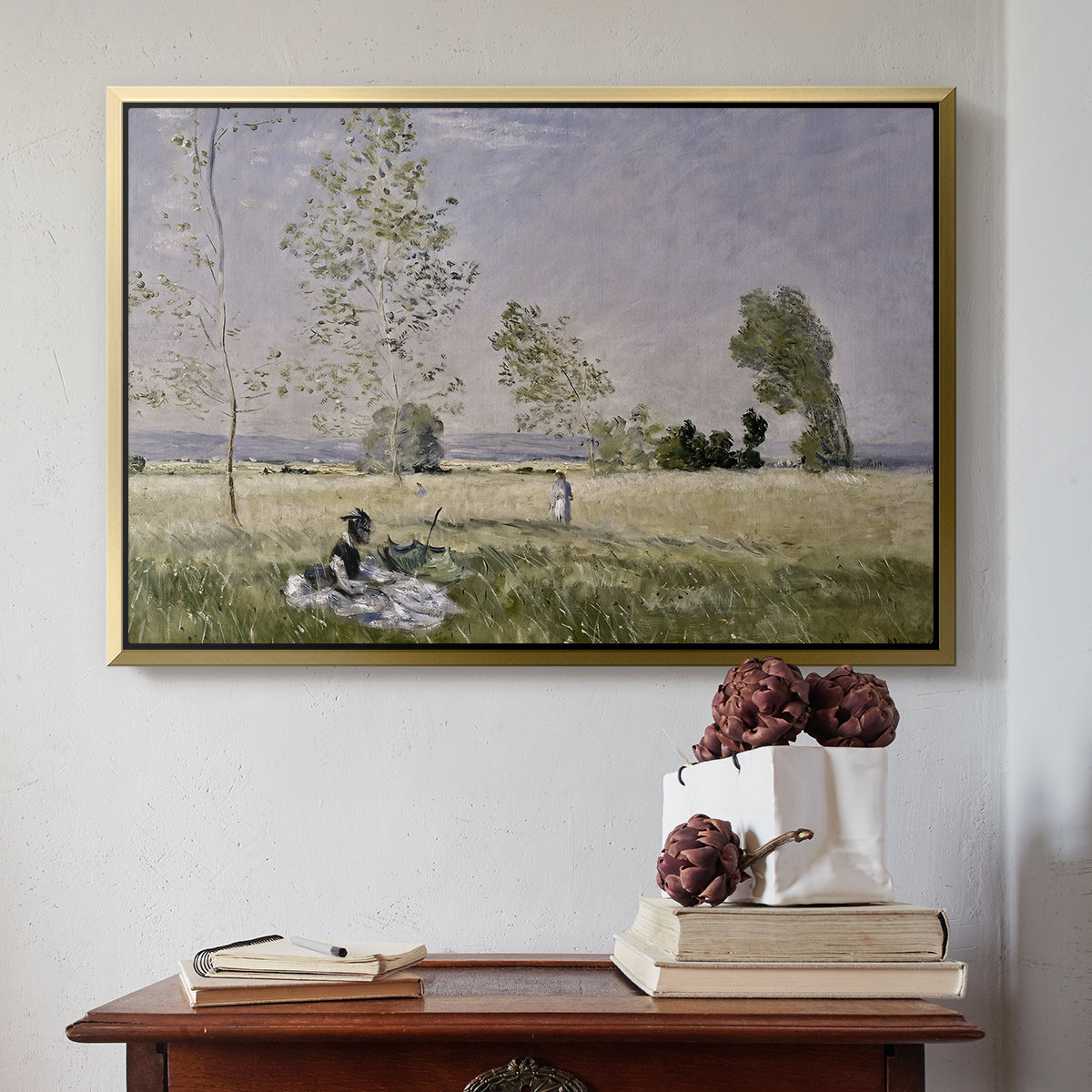 Gold floater framed canvas featuring Summer (L'ete), 1874 by Claude Monet above an entryway table in a minimalist foyer.