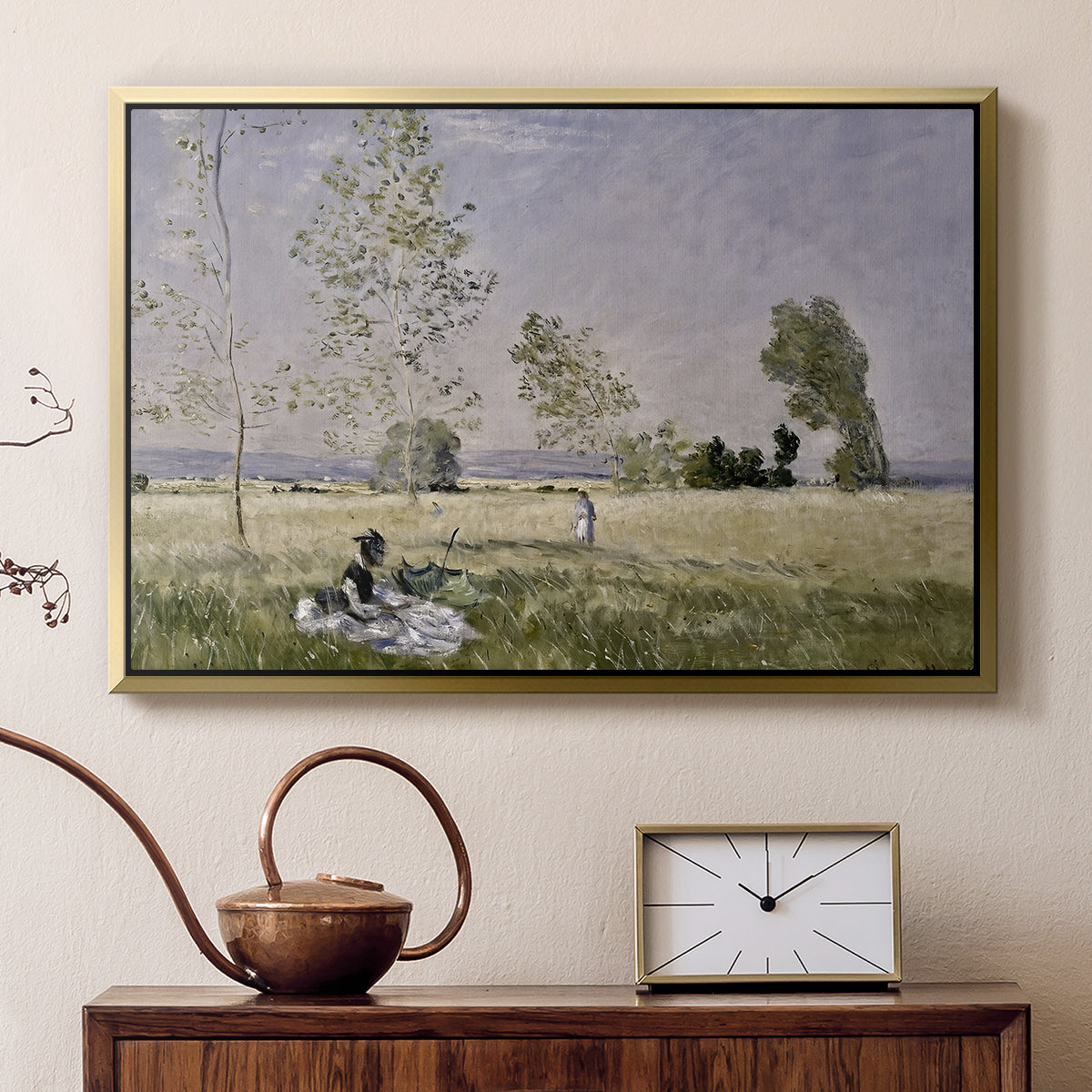 Gold floater framed canvas featuring a sunlit meadow with woman surrounded by greenery, displayed above a cabinet in a soft-toned living room.