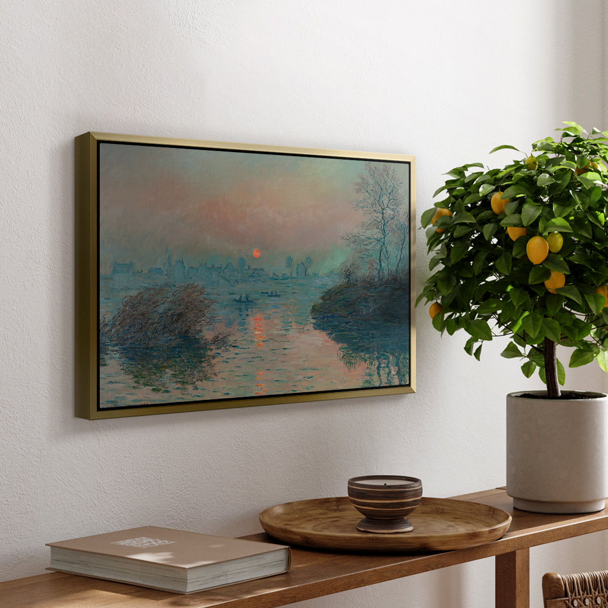 Sunset on the Seine at Lavacourt, Winter Effect, 1880 by Claude Monet, presented in a gold floater framed canvas featuring a glowing sunset over snowy river landscape with soft reflections, displayed above a hallway console table.