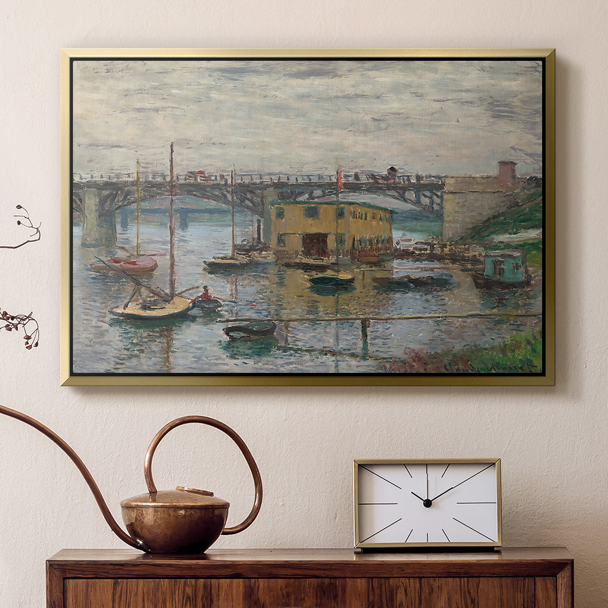 Gold floater framed canvas featuring a calm water scene with bridge fading into cloudy sky, displayed above a cabinet in a soft-toned living room.