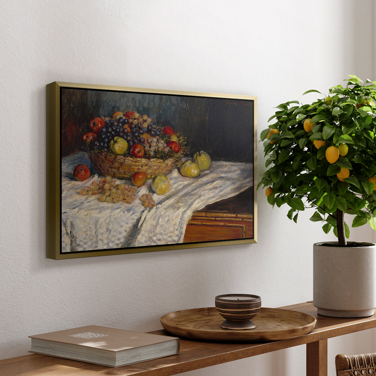 Still Life with Apples and Grapes, 1880 by Claude Monet, presented in a gold floater framed canvas featuring an arrangement of apples and grapes on table with soft natural light, displayed above a hallway console table.