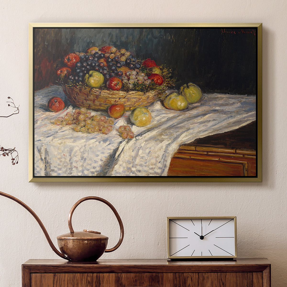 Gold floater framed canvas featuring a close-up of apples and grapes in warm tones, displayed above a cabinet in a soft-toned living room.
