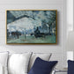 The Saint-Lazare Station, 1877 by Claude Monet displayed above a sofa in a living room in a gold floater frame, featuring an impressionist railway scene with locomotives and haze.