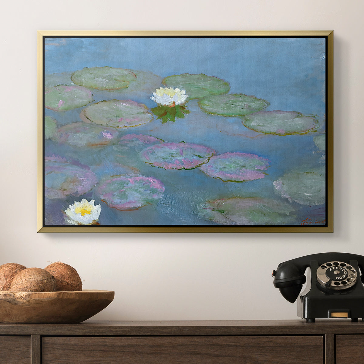 Water Lilies (Nymphéas), 1897-1899 by Claude Monet in a gold floater framed canvas displayed above a console table in a hallway, featuring a close-up of aquatic plants in still water.