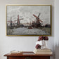 Gold floater framed canvas featuring Windmills near Zaandam, 1871 by Claude Monet above an entryway table in a minimalist foyer.