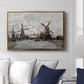 Windmills near Zaandam, 1871 by Claude Monet displayed above a sofa in a living room in a gold floater frame, featuring an impressionist view of Dutch windmills along riverbank.