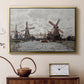 Gold floater framed canvas featuring a countryside scene with traditional windmills and reflections, displayed above a cabinet in a soft-toned living room.