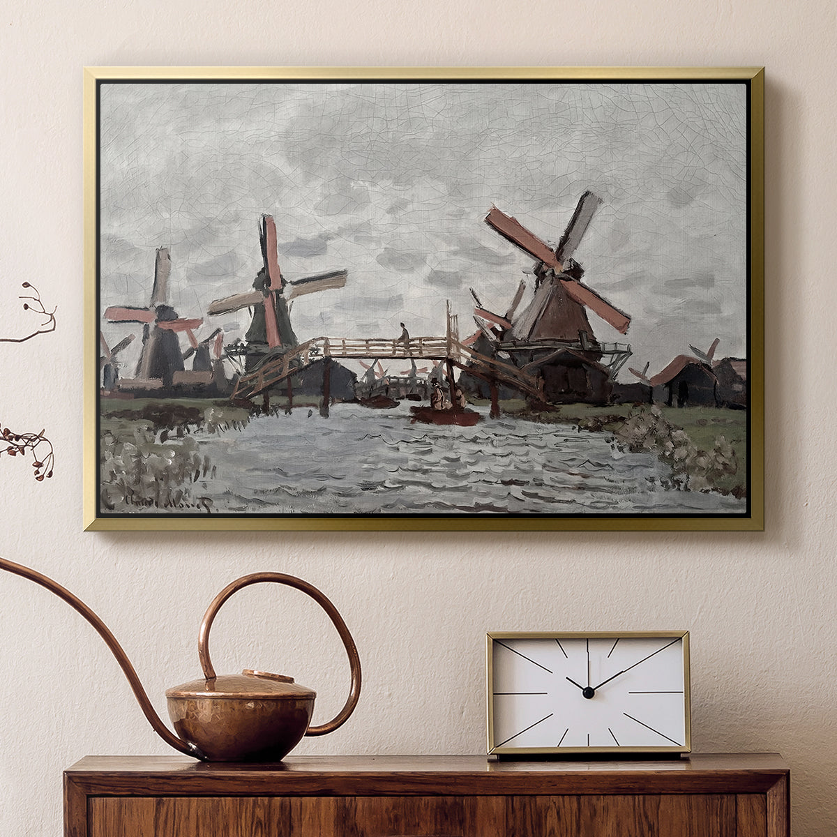 Gold floater framed canvas featuring a countryside scene with traditional windmills and reflections, displayed above a cabinet in a soft-toned living room.