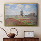 Gold floater framed canvas featuring an impressionist field of blooming tulips under bright sky, displayed above a cabinet in a soft-toned living room.