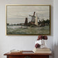 Gold floater framed canvas featuring Windmill at Zaandam, 1871 by Claude Monet above an entryway table in a minimalist foyer.
