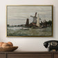 Windmill at Zaandam, 1871 by Claude Monet in a gold floater framed canvas displayed above a console table in a hallway, featuring a countryside structure standing against open sky.
