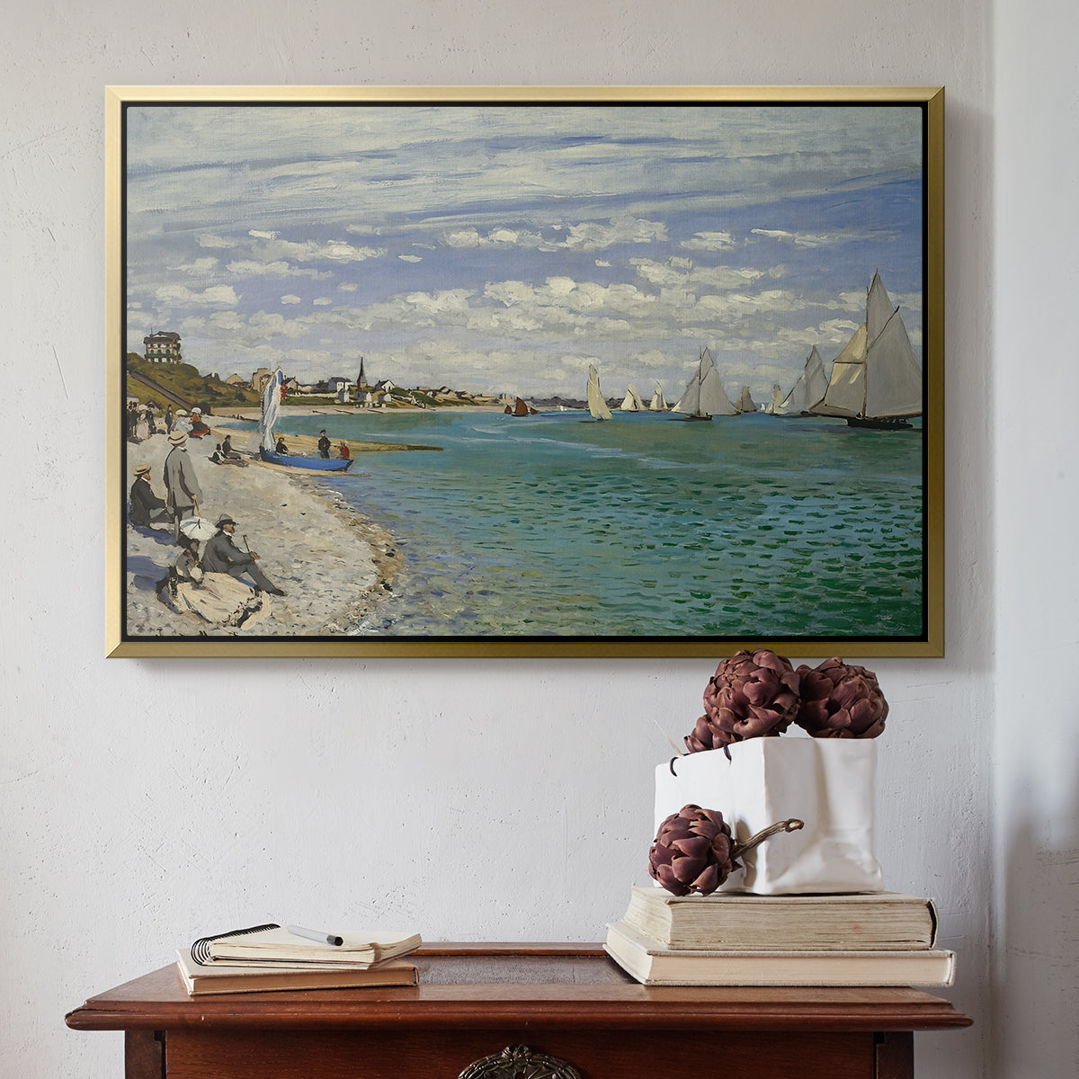 Gold floater framed canvas featuring Regatta at Sainte-Adresse, 1867 by Claude Monet above an entryway table in a minimalist foyer.
