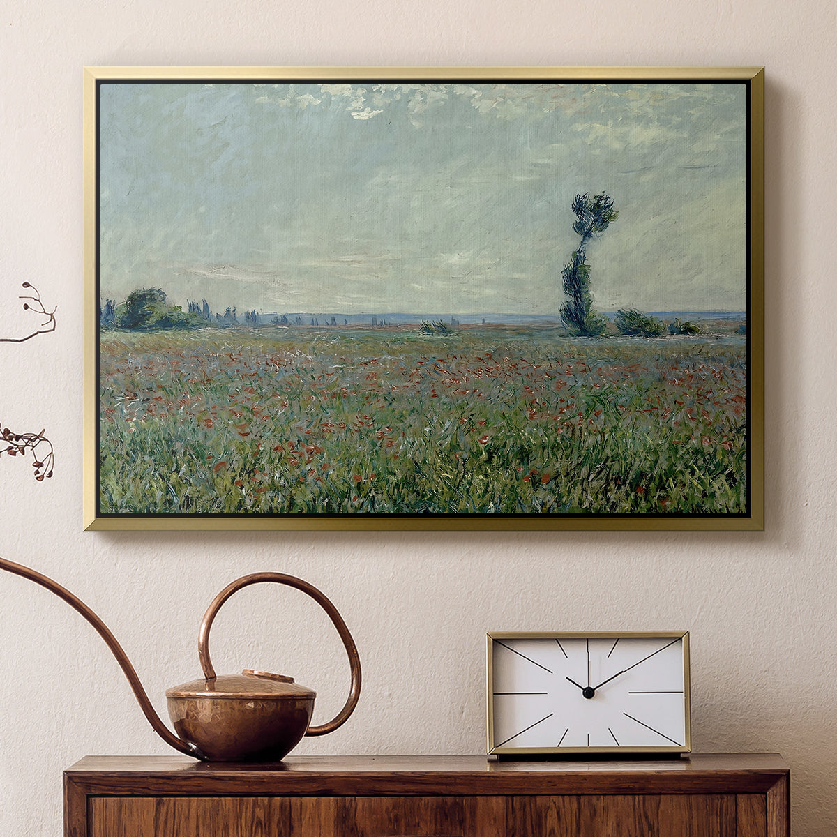 Gold floater framed canvas featuring a rural meadow with scattered poppies and soft horizon, displayed above a cabinet in a soft-toned living room.