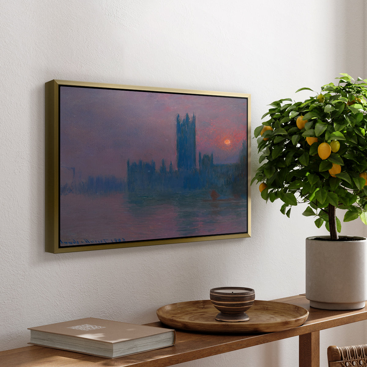 The Houses of Parliament, Sunset, 1903 by Claude Monet, presented in a gold floater framed canvas featuring a silhouette of Parliament buildings against glowing sunset across river, displayed above a hallway console table.