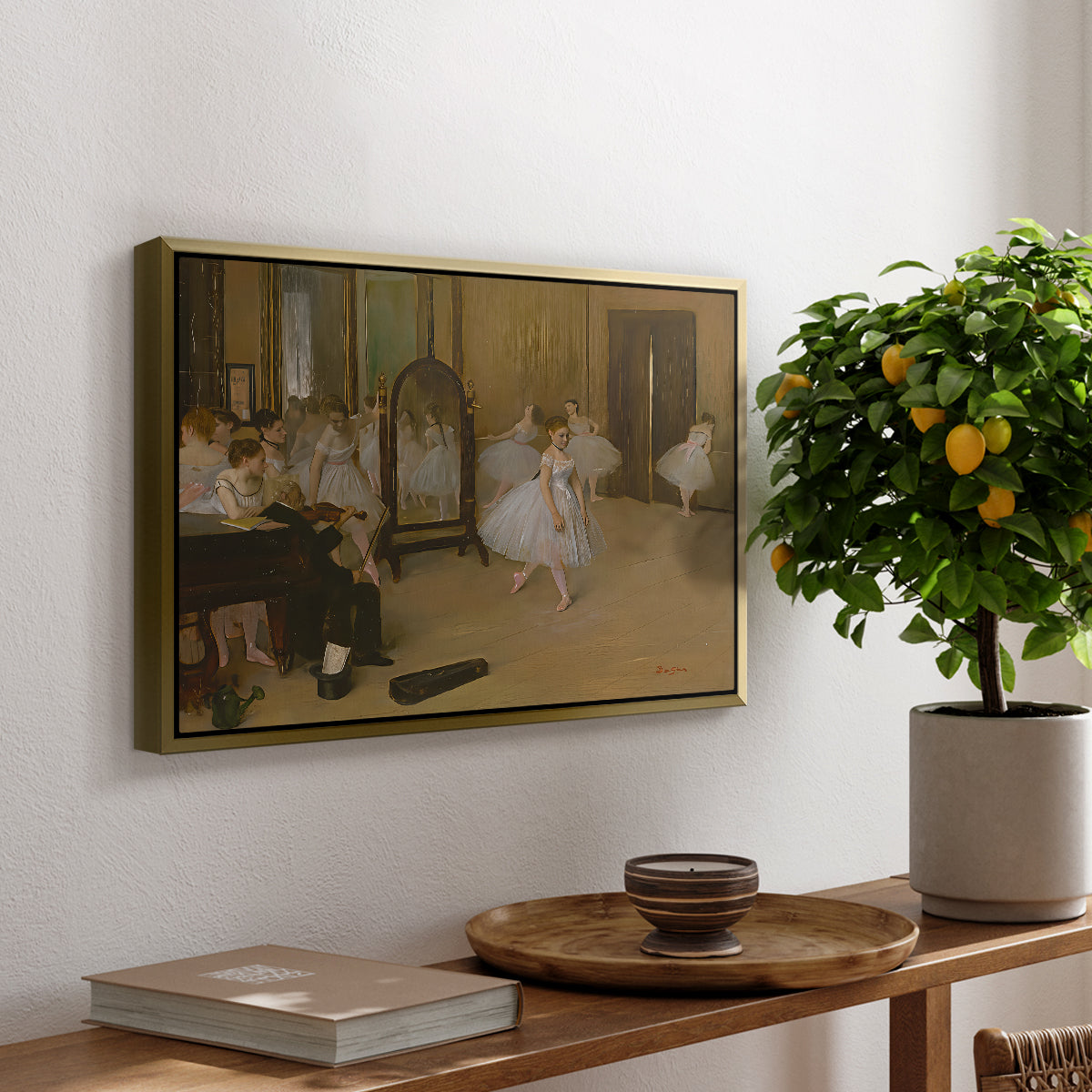 The Dancing Class, c. 1870 by Edgar Degas, presented in a gold floater framed canvas featuring a ballet class with dancers practicing positions under instructor guidance, displayed above a hallway console table.