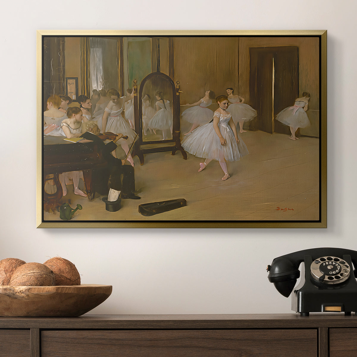 The Dancing Class, c. 1870 by Edgar Degas in a gold floater framed canvas displayed above a console table in a hallway, featuring a group of dancers mid-practice with teacher overseeing.