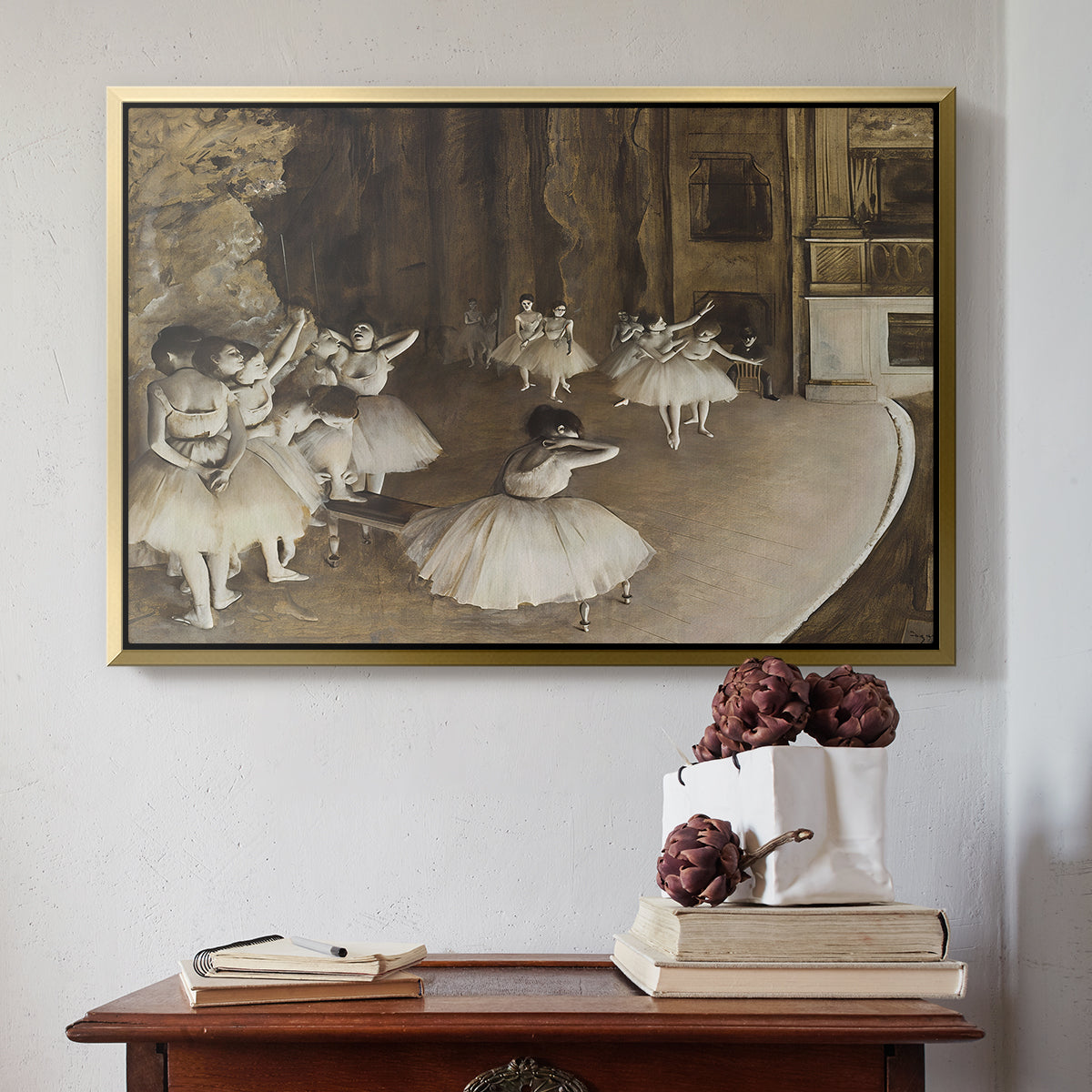 Gold floater framed canvas featuring The Rehearsal of the Ballet Onstage, 1874 by Edgar Degas above an entryway table in a minimalist foyer.