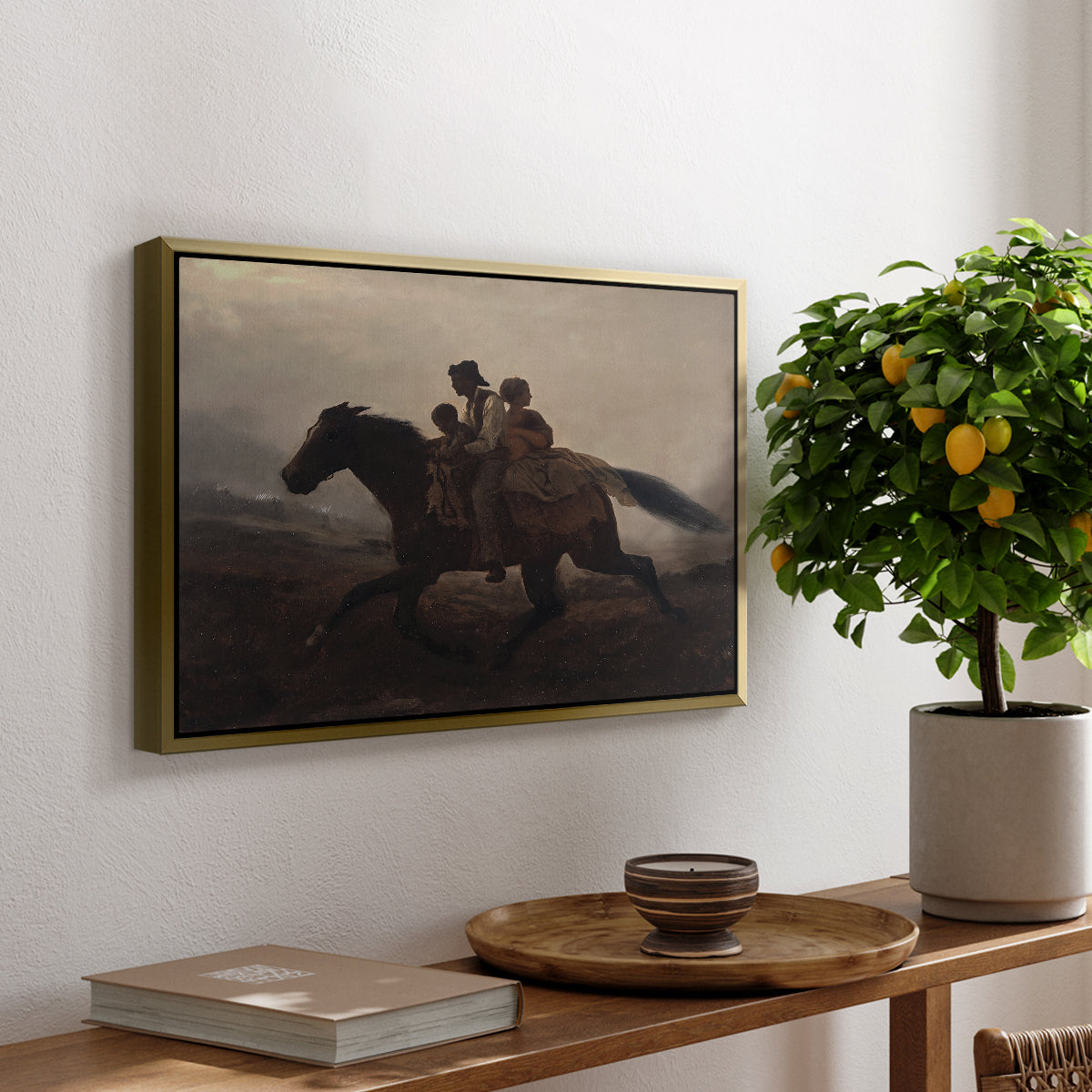 A Ride for Liberty – The Fugitive Slaves, c. 1862 by Eastman Johnson, presented in a gold floater framed canvas featuring a family riding horseback through night escaping across landscape, displayed above a hallway console table.