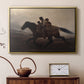 Gold floater framed canvas featuring a narrative painting of escape and urgency across rugged terrain, displayed above a cabinet in a soft-toned living room.