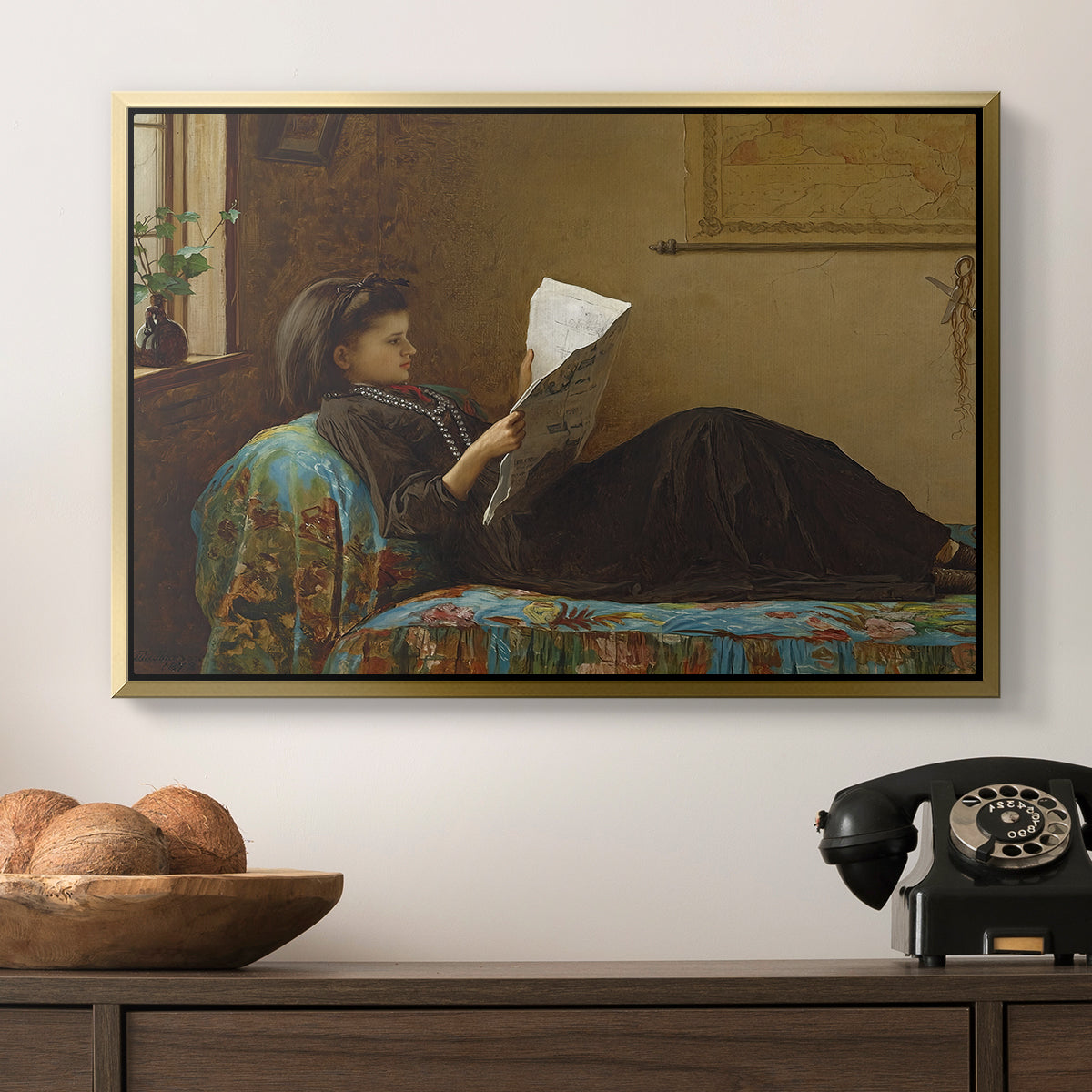 Interesting News, 1872 by Eastman Johnson in a gold floater framed canvas displayed above a console table in a hallway, featuring a casual gathering around newspaper in rustic room.