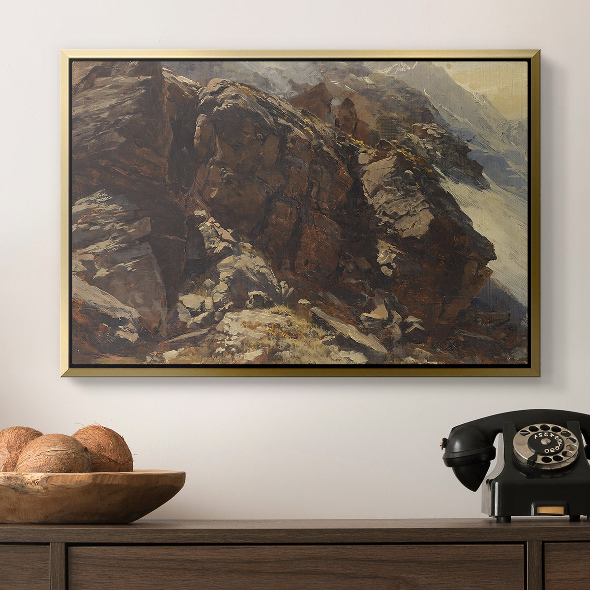 High Mountain Study, c. 1870 by Edward Theodore Compton in a gold floater framed canvas displayed above a console table in a hallway, featuring a realistic depiction of mountainous terrain under open sky.
