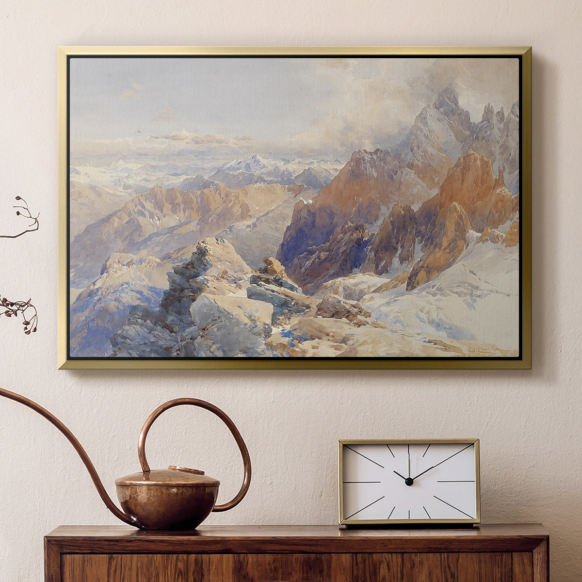 Gold floater framed canvas featuring a panoramic alpine view with snow and rocky cliffs, displayed above a cabinet in a soft-toned living room.