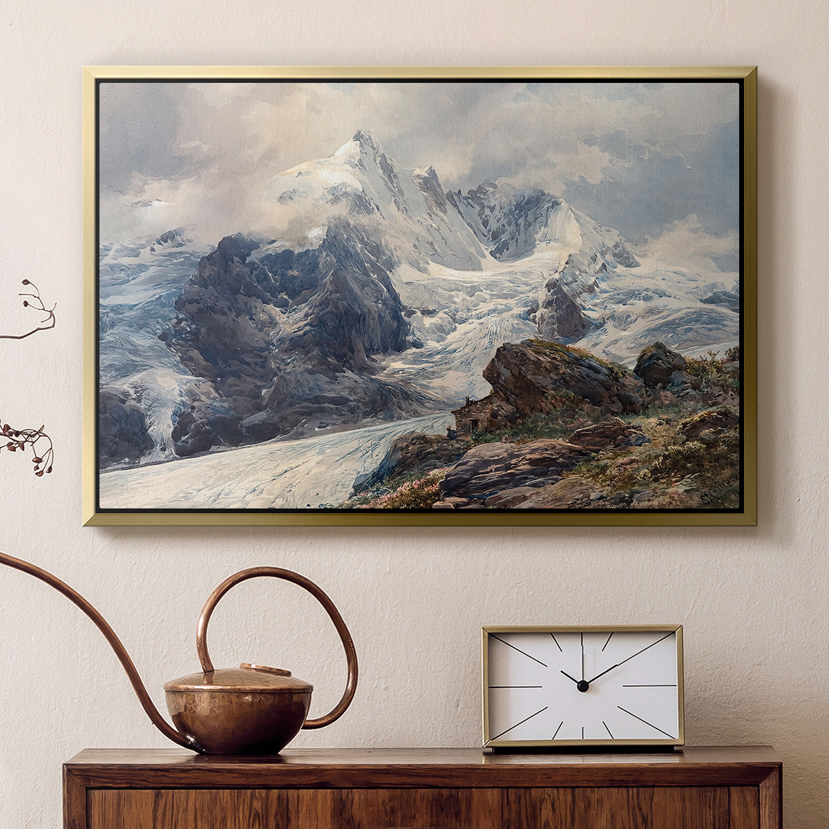Gold floater framed canvas featuring a realistic landscape of high mountain under open sky, displayed above a cabinet in a soft-toned living room.