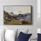The Großglockner from the Prager Hut, 1890 by Edward Theodore Compton displayed above a sofa in a living room in a gold floater frame, featuring a mountain summit seen from elevated viewpoint with surrounding landscape.