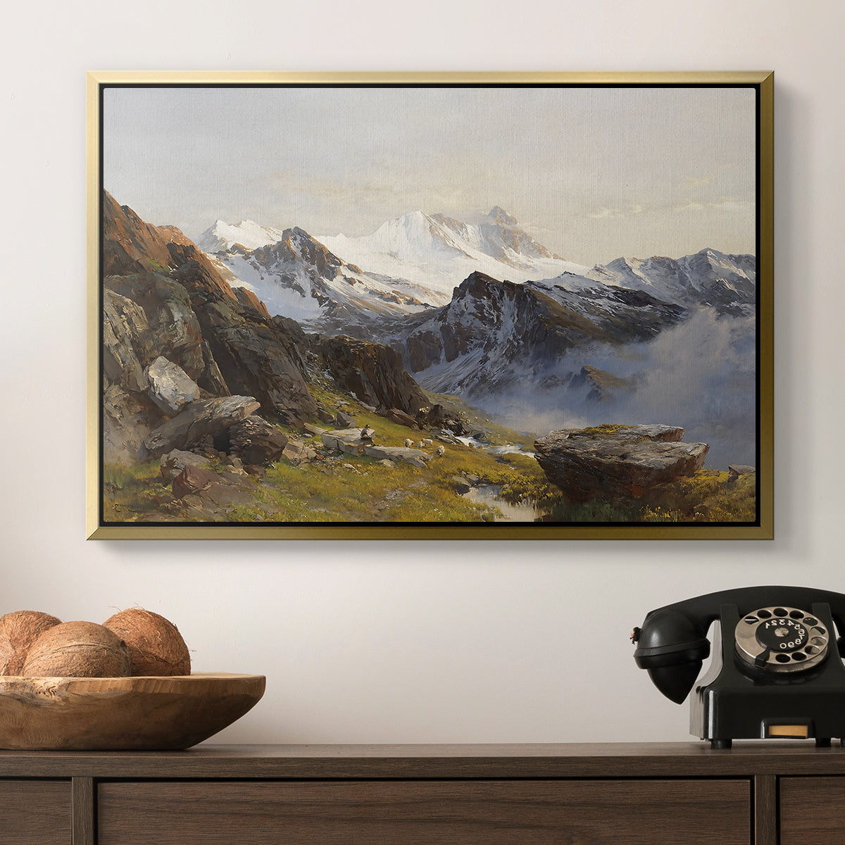 The Großglockner from the Prager Hut, 1890 by Edward Theodore Compton in a gold floater framed canvas displayed above a console table in a hallway, featuring a scenic mountain view with dramatic elevation and depth.