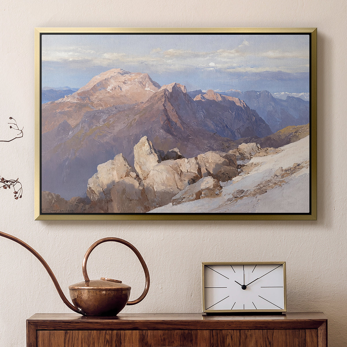 Gold floater framed canvas featuring a high vantage point overlooking rugged mountain terrain, displayed above a cabinet in a soft-toned living room.