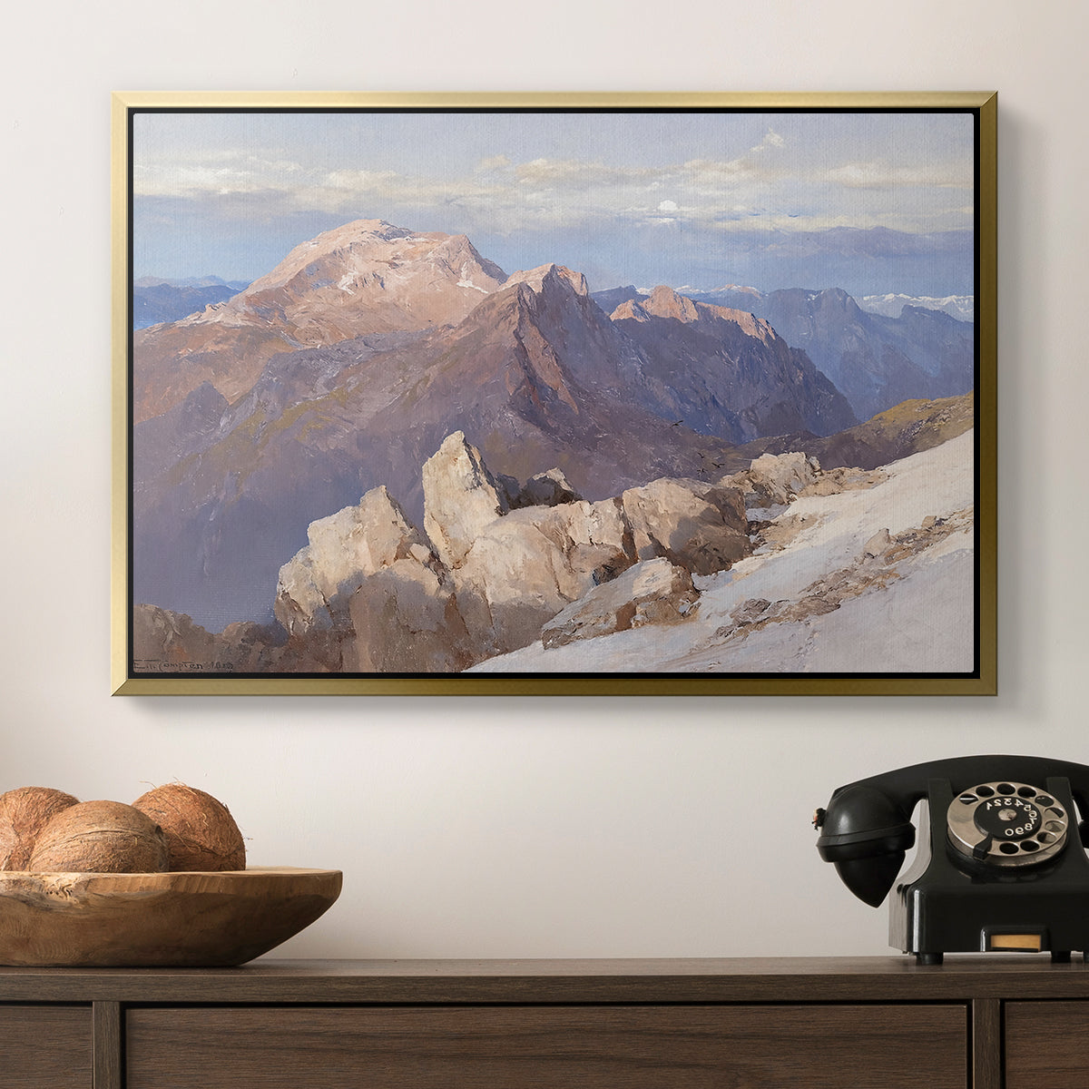 Hoher Göll from Watzmann-Hocheck, 1919 by Edward Theodore Compton in a gold floater framed canvas displayed above a console table in a hallway, featuring an expansive mountainous landscape with natural depth.