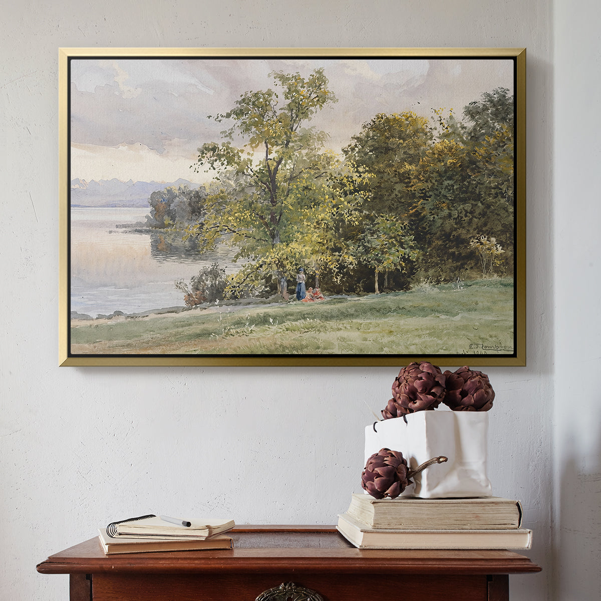 Gold floater framed canvas featuring Landscape at Lake Starnberg, 1890 by Edward Theodore Compton above an entryway table in a minimalist foyer.